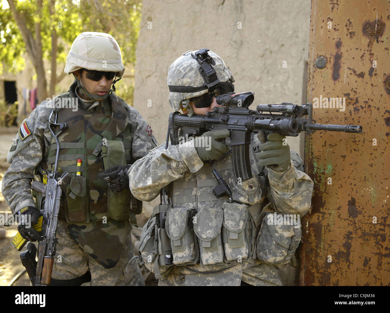 US Army soldiers return fire on insurgents during a combat operation February 11, 2007 in Buhriz, Iraq. Stock Photo