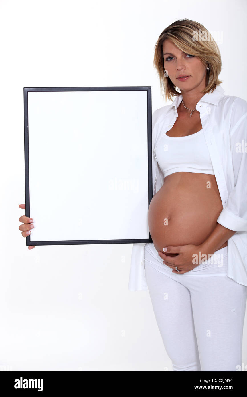 Pregnant women holding picture frame Stock Photo
