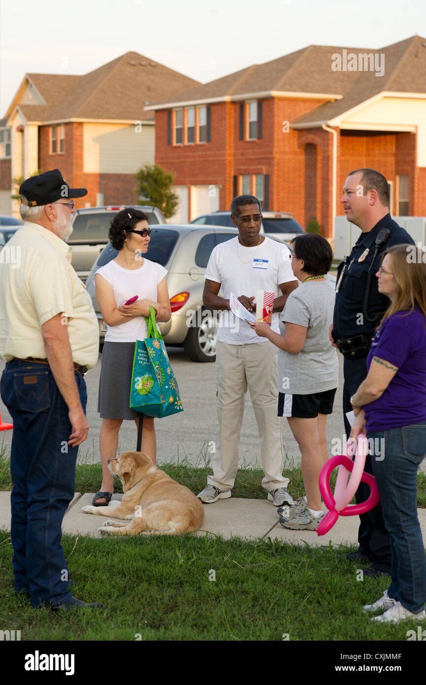 Families gather at neighborhood park with police for the annual  National Night Out gathering to interact with neighbors talk Stock Photo