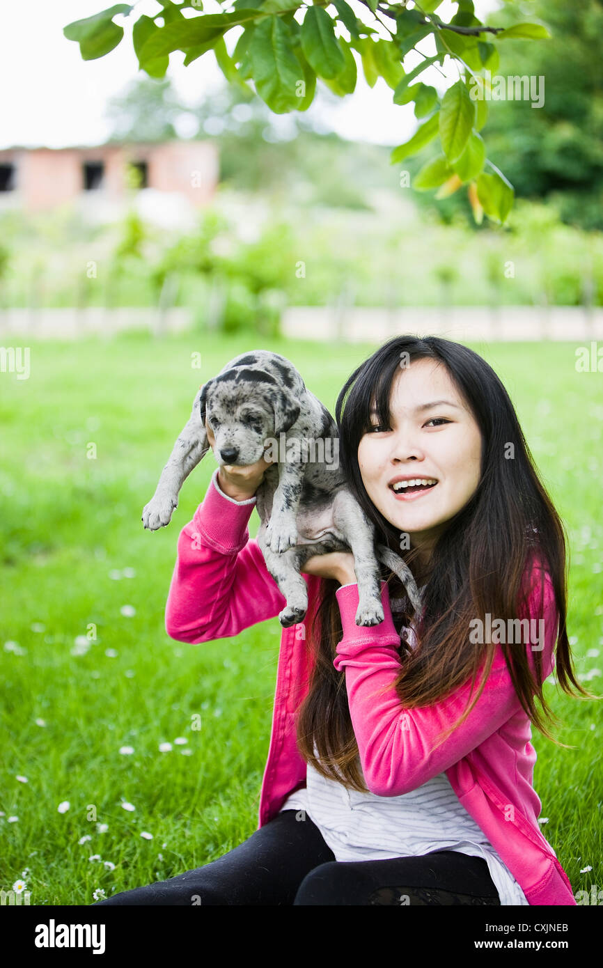 Pretty Girl Playing with Puppy Dog in Garden Stock Photo - Alamy