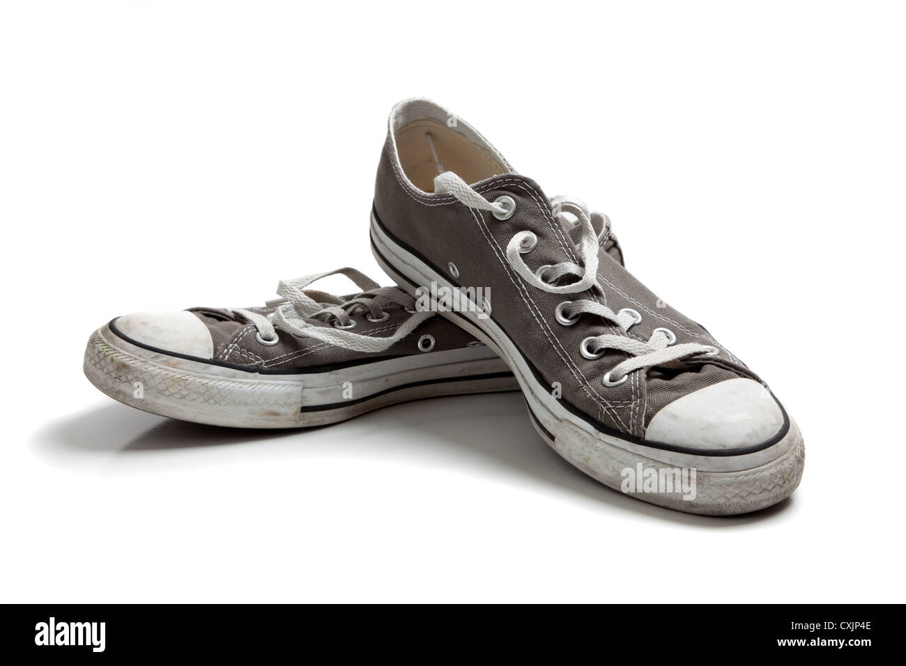 Pair of old, retro gray sneakers on a white background Stock Photo - Alamy