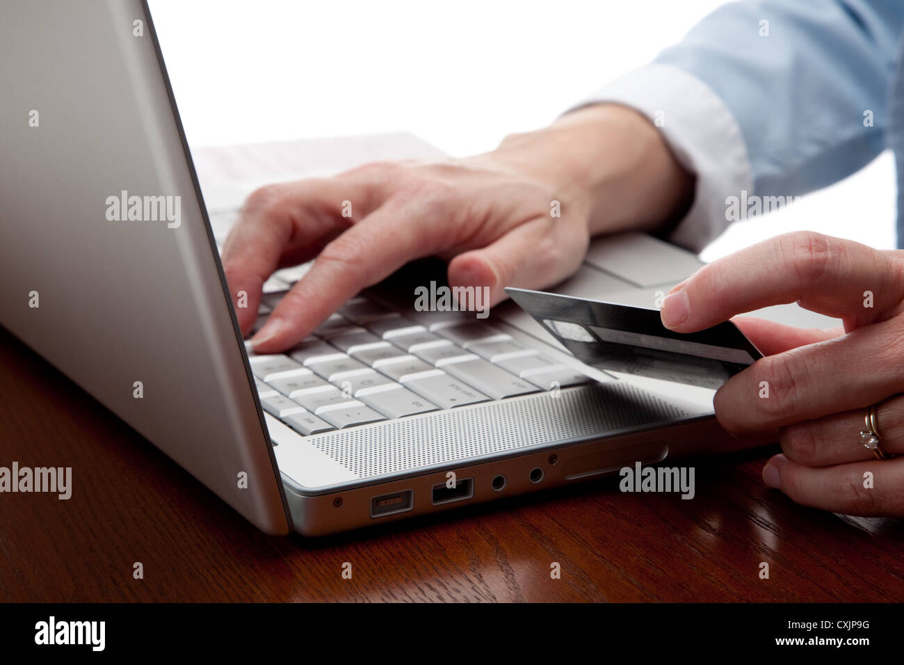 Woman hand with a laptop keyboard and credit card shopping on-line Stock Photo