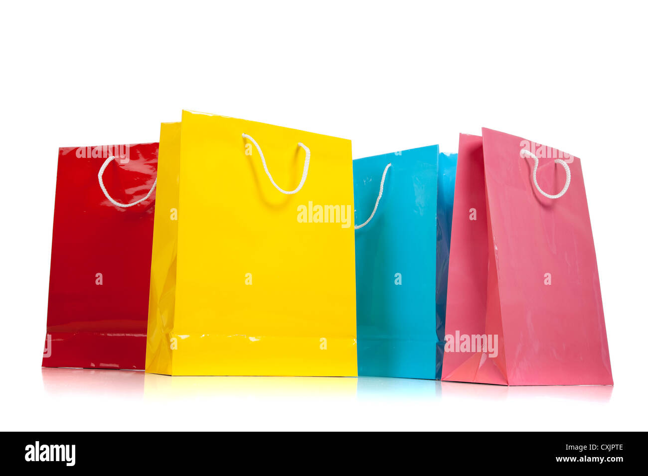 Row of various colored shopping bags on a white background Stock Photo