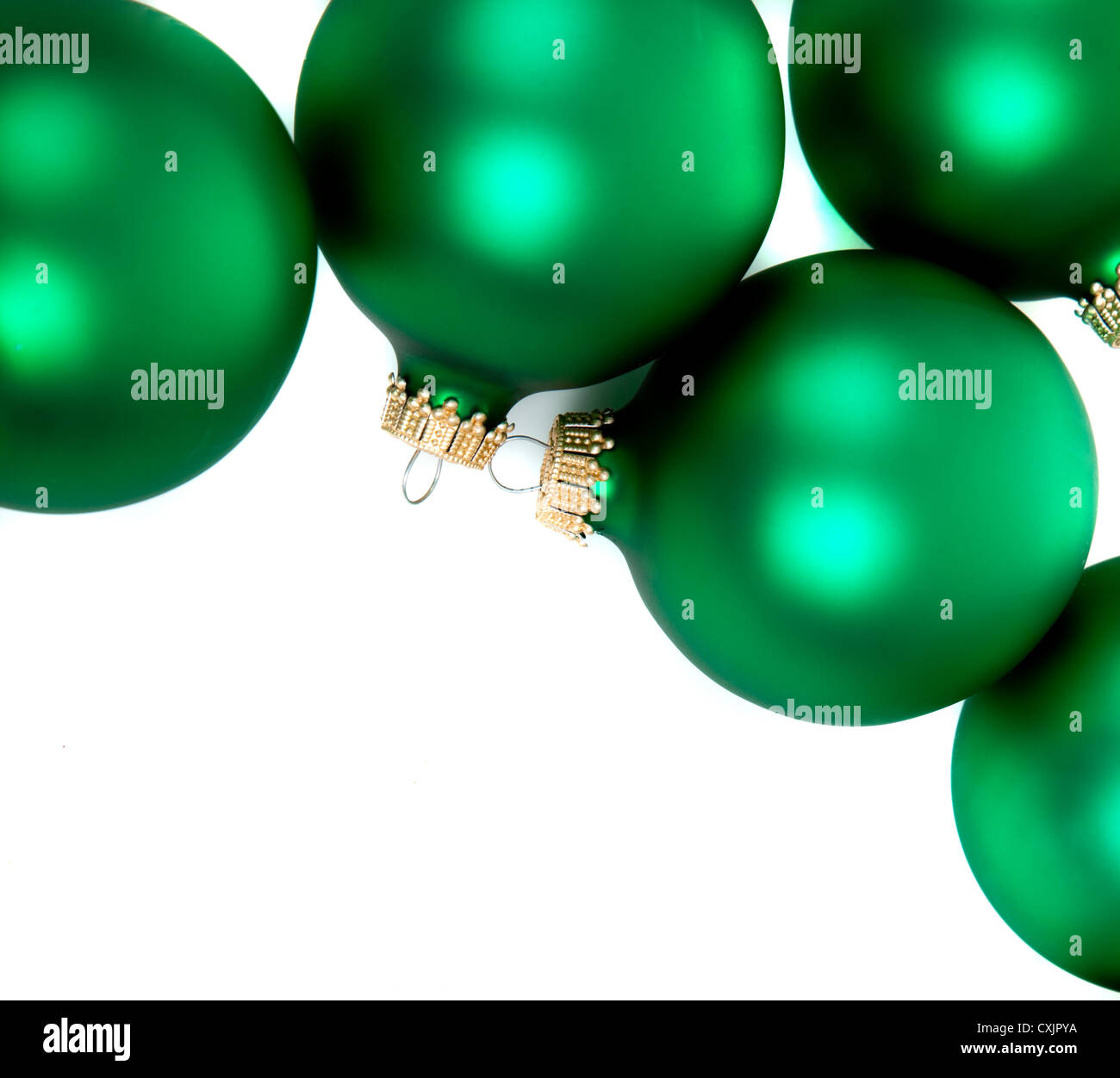 Green Christmas ornaments on a white background with copy space Stock