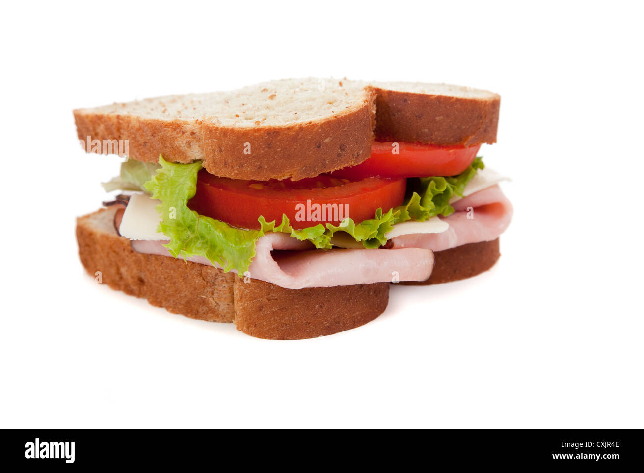 A ham sandwich on wheat bread on a white background Stock Photo