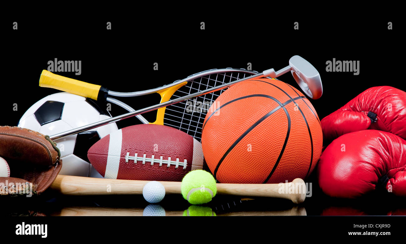 Various sports equipment on a black background Stock Photo - Alamy