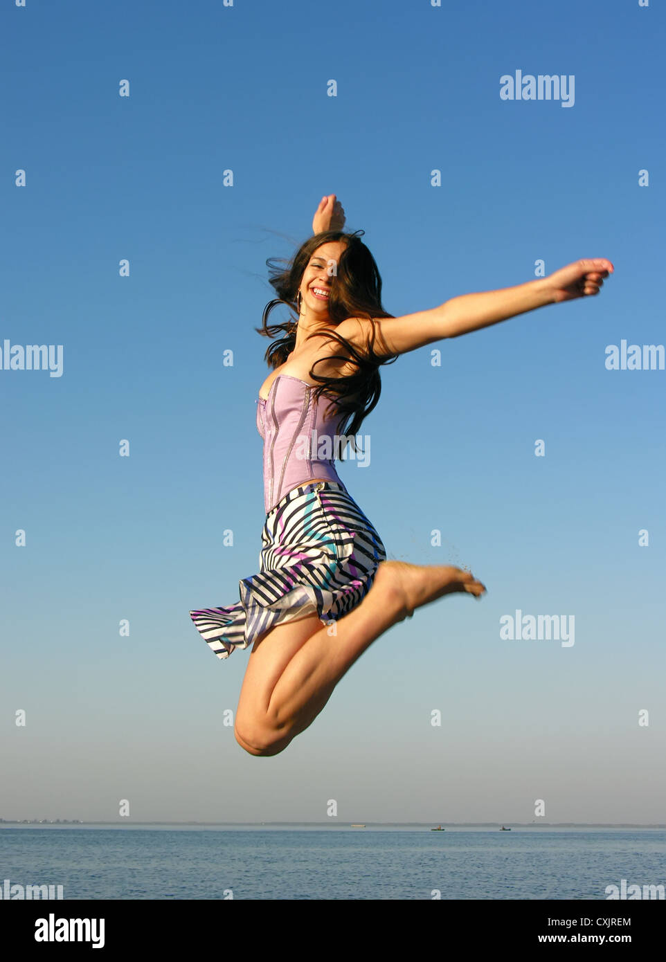 Happy fitness woman jumping hi-res stock photography and images - Alamy