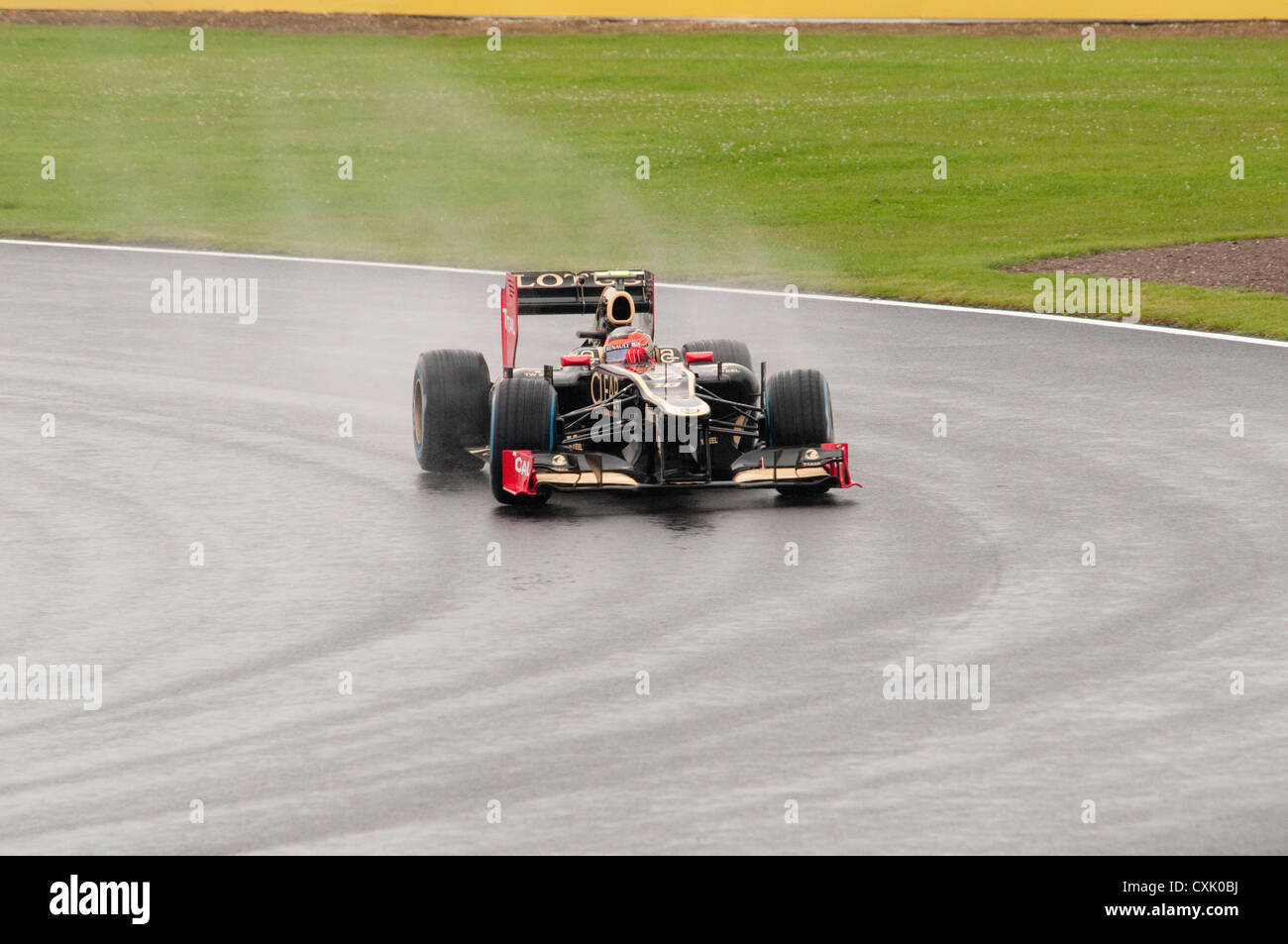 Romain Grosjean in his Lotus F1 Car in the Wet Stock Photo
