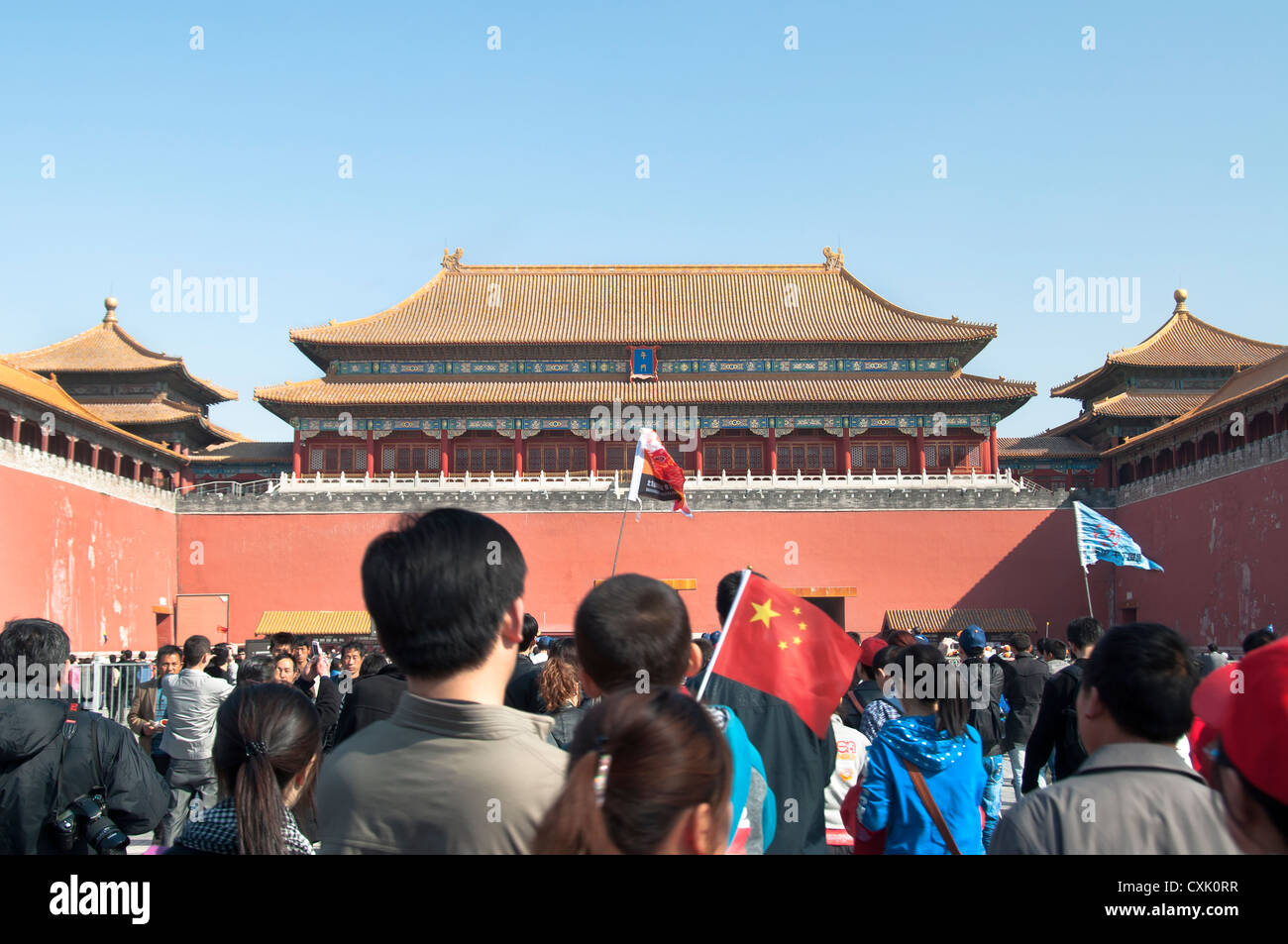 Small boy waving a Chinese national flag at the Forbidden City, China Stock Photo