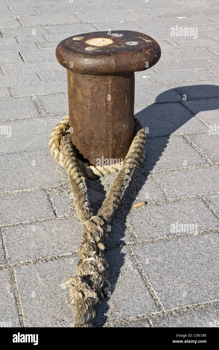 Bollard with rope Stock Photo