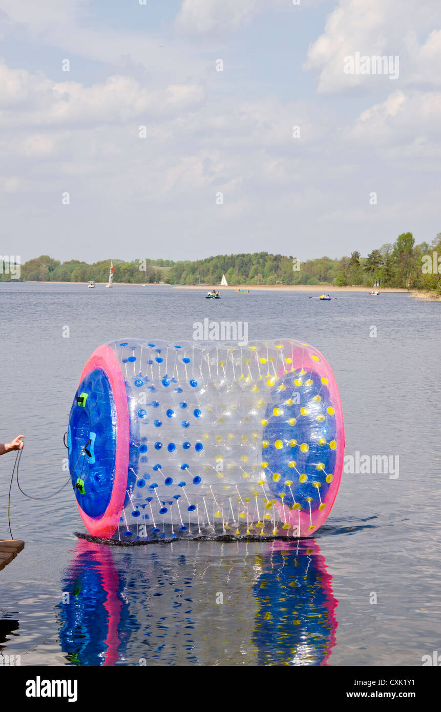 empty zorbing ball on resort lake water Stock Photo