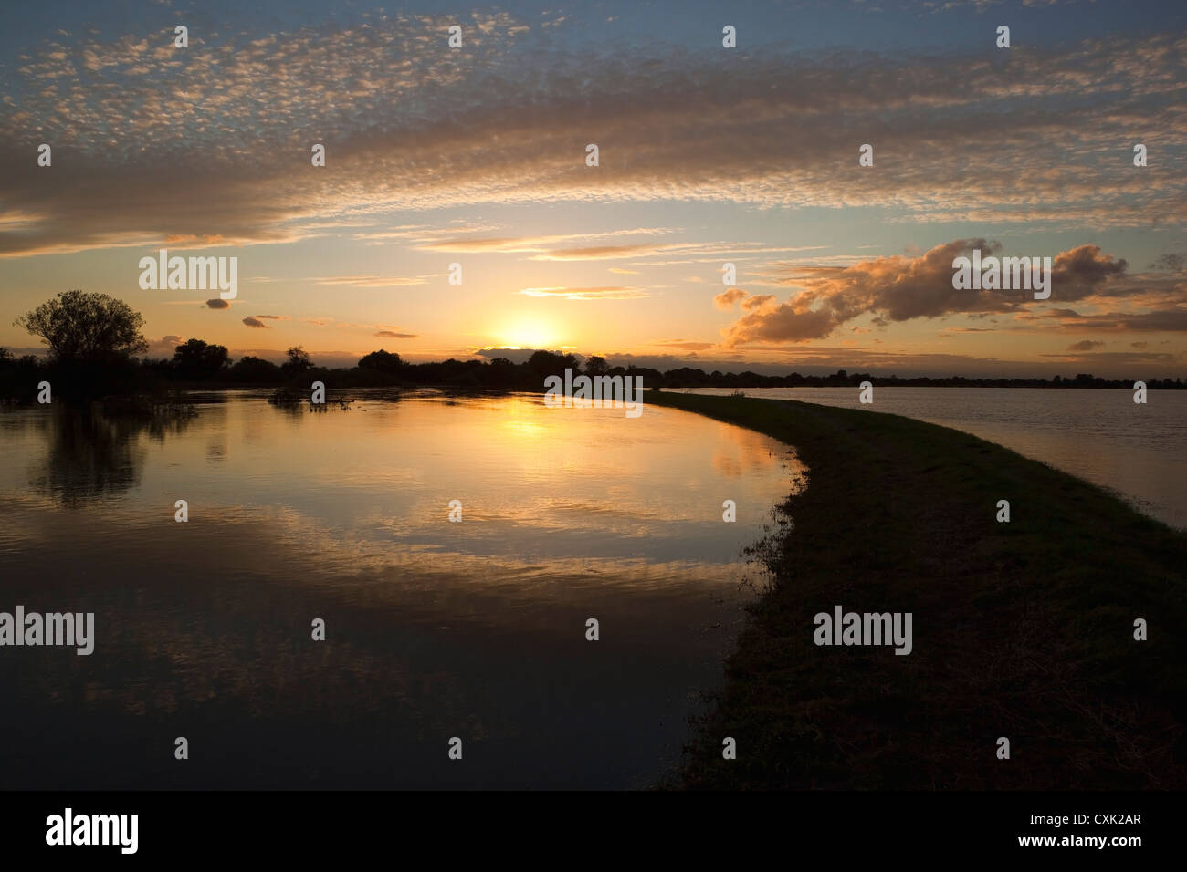 An Autumn landscape with sunset over the flood waters of the lower Derwent valley in Yorkshire england Stock Photo