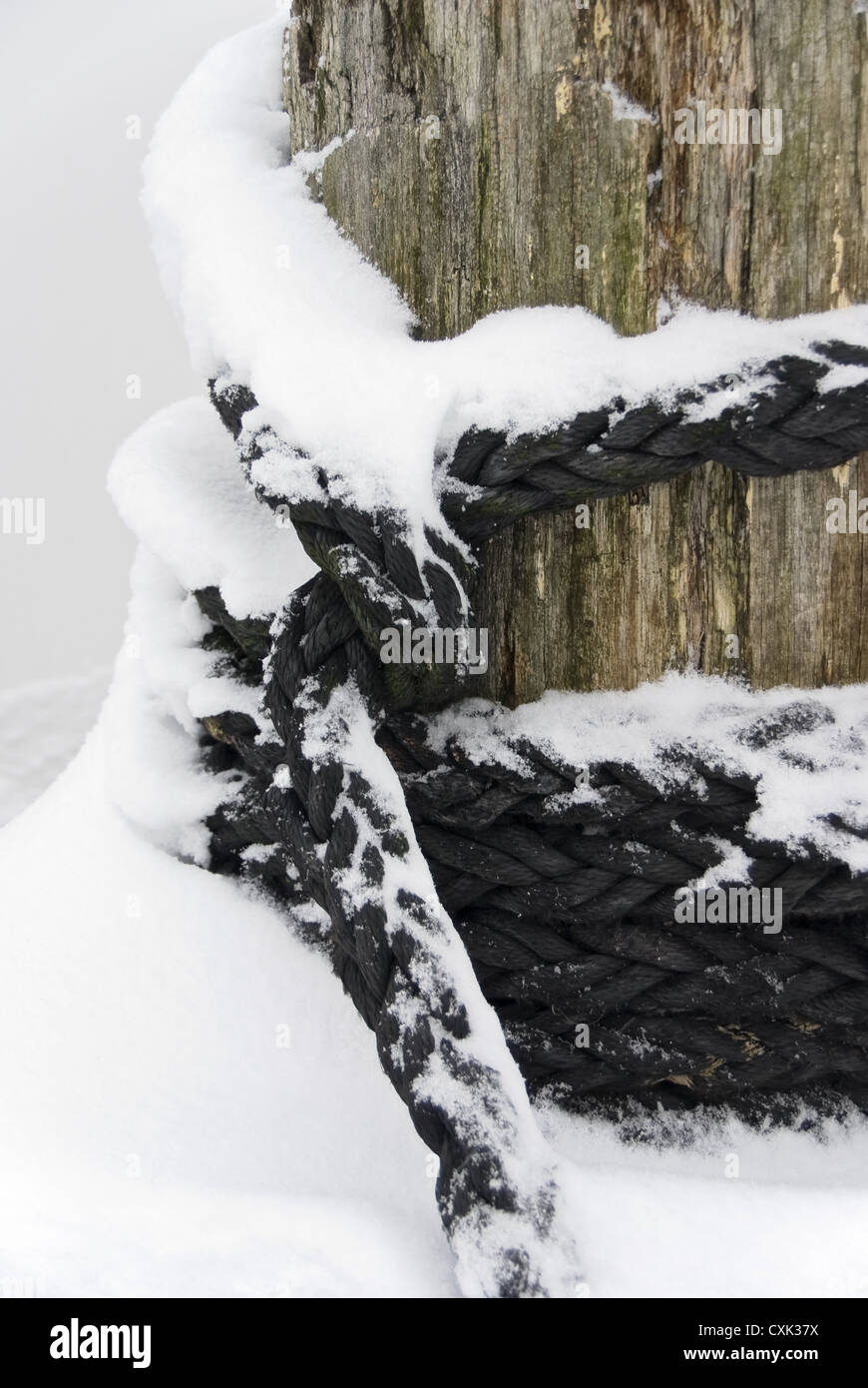 Bollard with rope in the winter Stock Photo