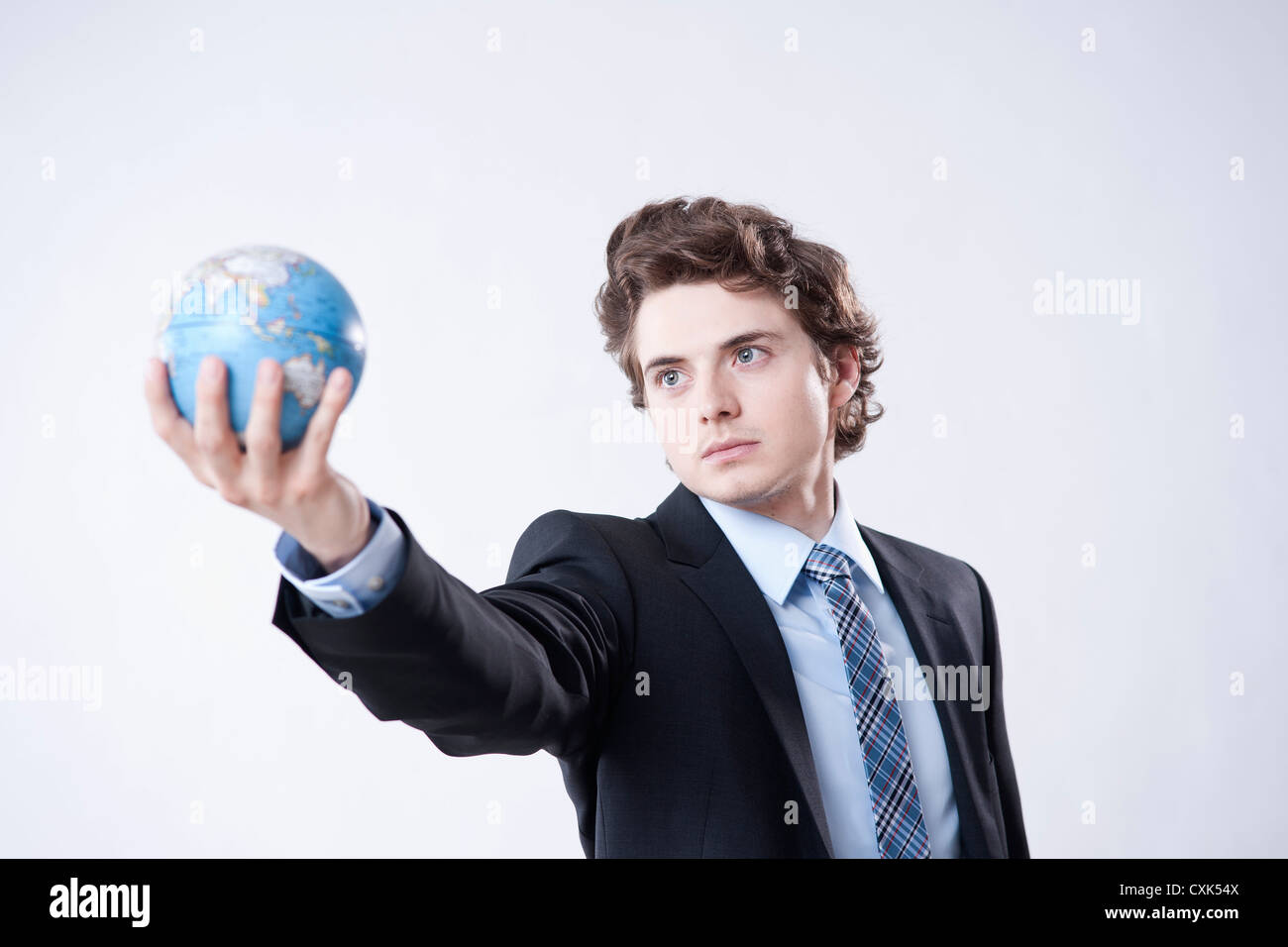 Portrait of Young Businessman holding World Globe Stock Photo - Alamy