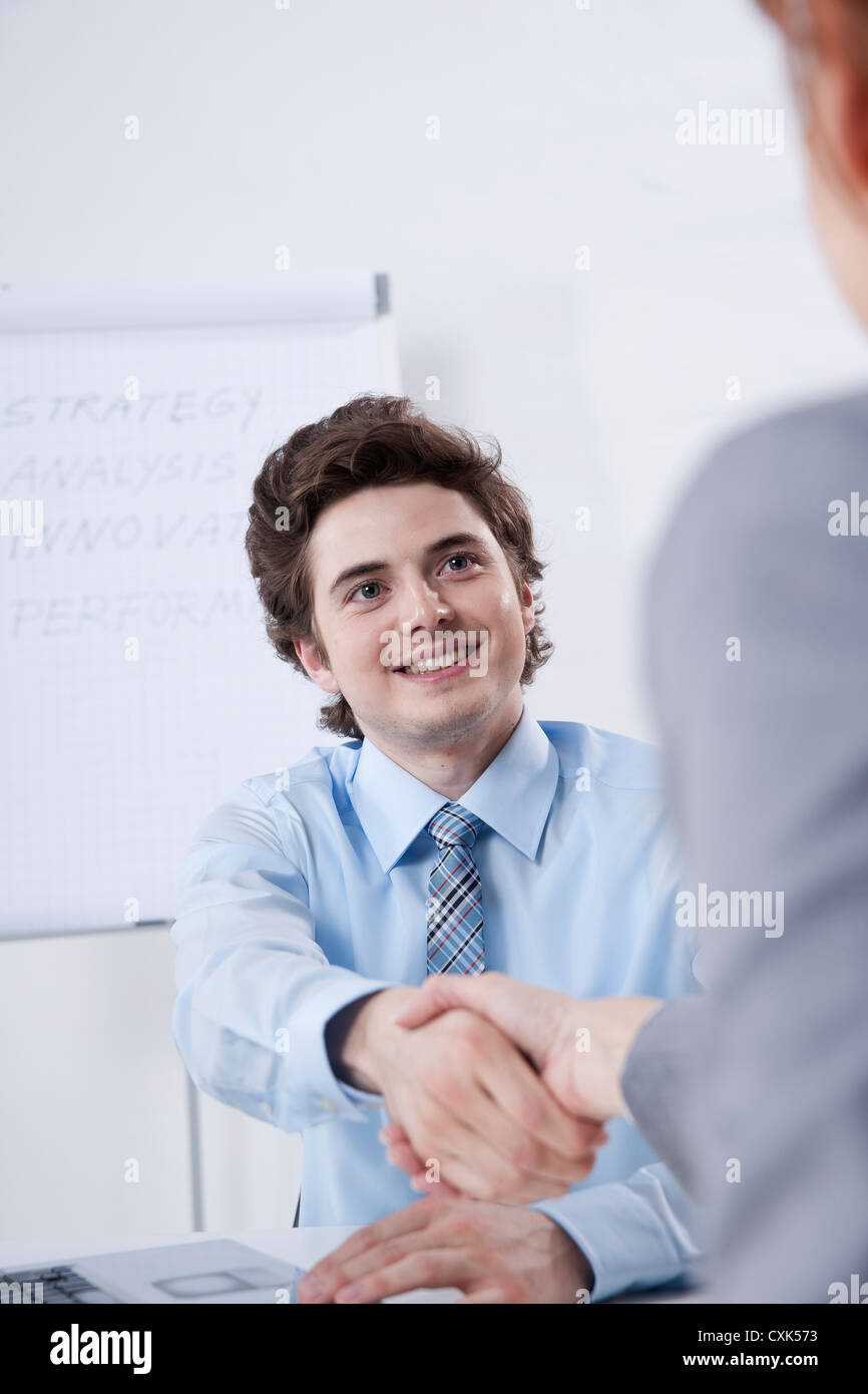 Young Businessman Shaking Hands with Businesswoman Stock Photo Alamy