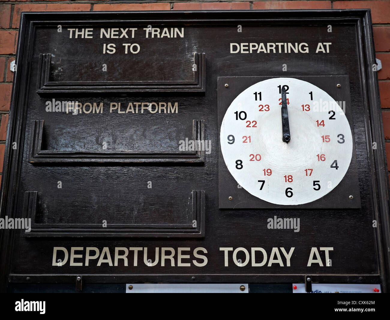 Vintage train departure announcement board and clock at Toddington Historic train station Gloucestershire England UK Stock Photo
