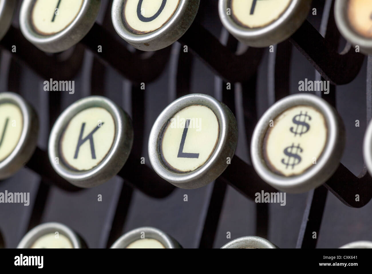 A closeup of an antique typewriter and the keys and letters and bars