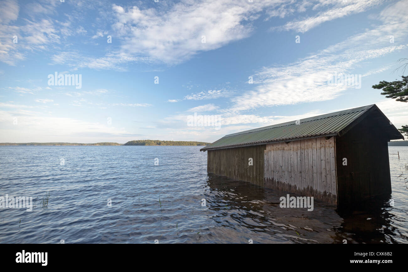 Small wooden boat garage on the coast of Saimaa lake, typically construction for Finland Stock Photo