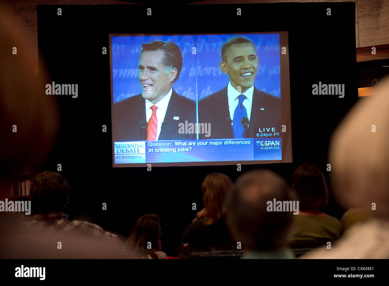 Likely voters watch large TV screen showing televised debate between US presidential candidates Barack Obama and Mitt Romney Stock Photo