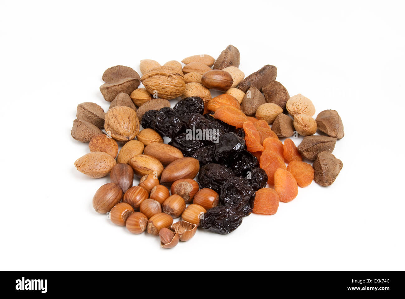 Dried prunes and assortment of nuts isolated, healthy food concept. Stock Photo