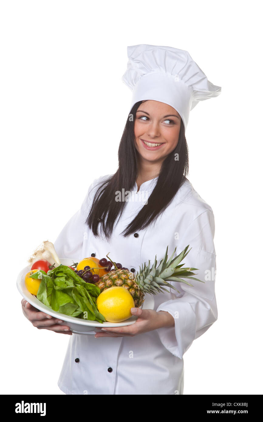 Young cook serving a plate of fruit and vegetables Stock Photo