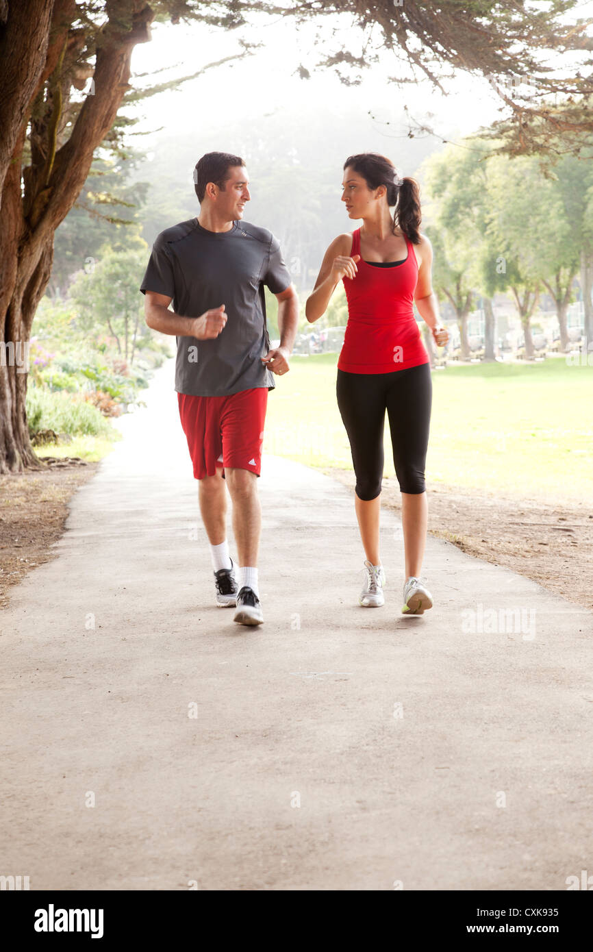 Two joggers are running along a path Stock Photo Alamy