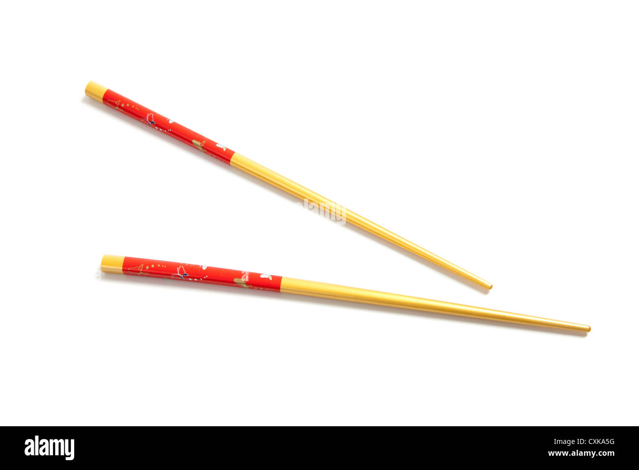 Red and yellow chopsticks on a white background Stock Photo