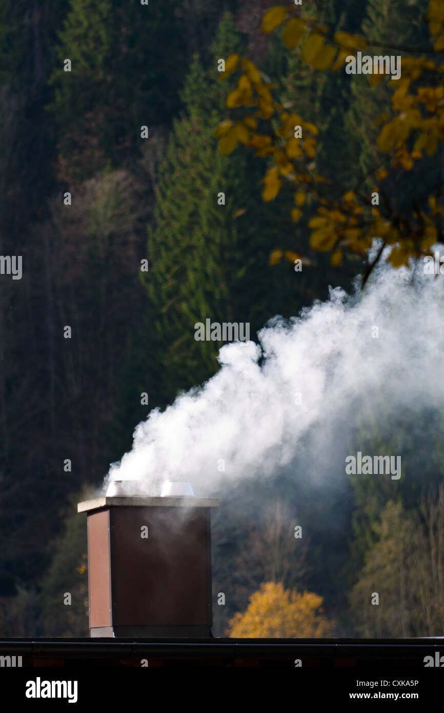 Smoking chimney of a house Stock Photo