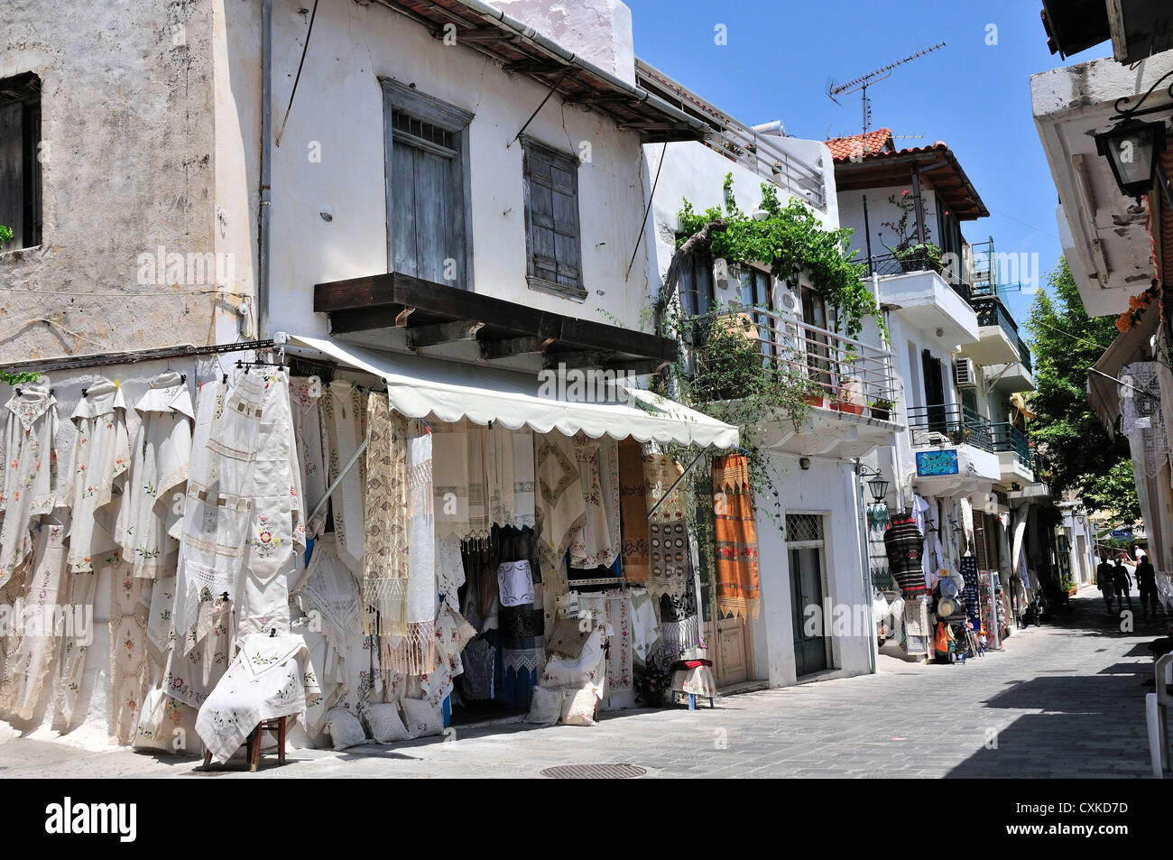 Street in Kritsa, near Agios Nikolaos, North East Coast, Crete, Greece showing village street and shop selling embroidered items Stock Photo