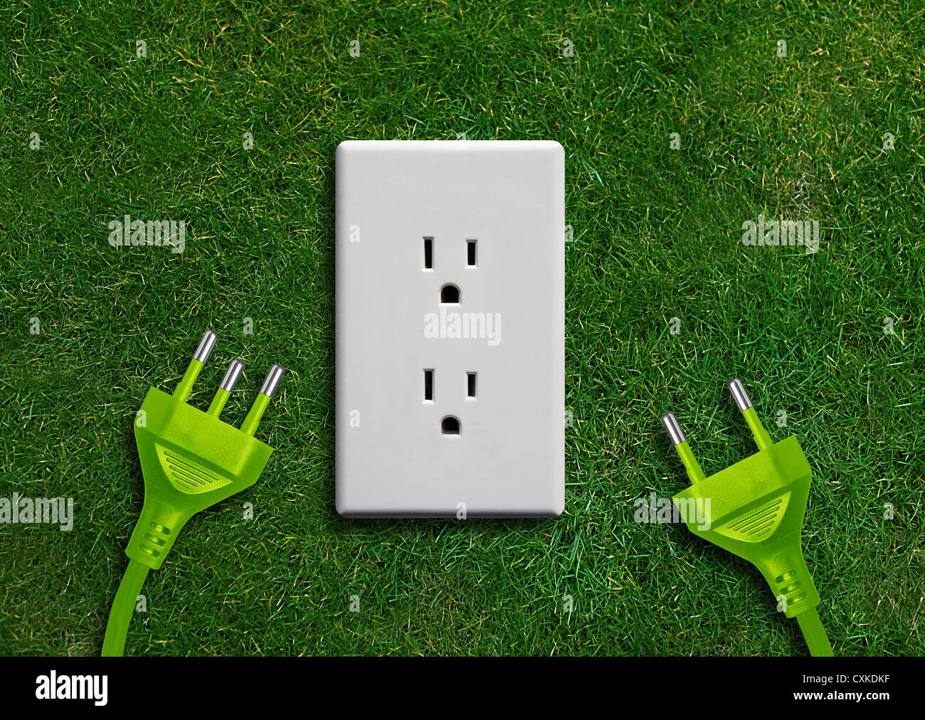 Green energy concept, Green power plug in electric outlet on a green grassland Stock Photo Alamy