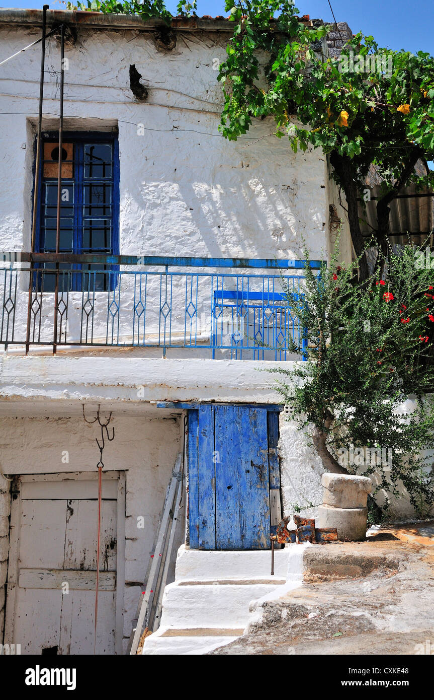 Whitewashed house with blue door in the hill village of Pano Elounda