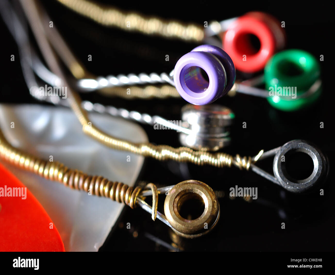 Acoustic copper bronze wound guitar strings with coloured beads for bridge  pins Stock Photo - Alamy