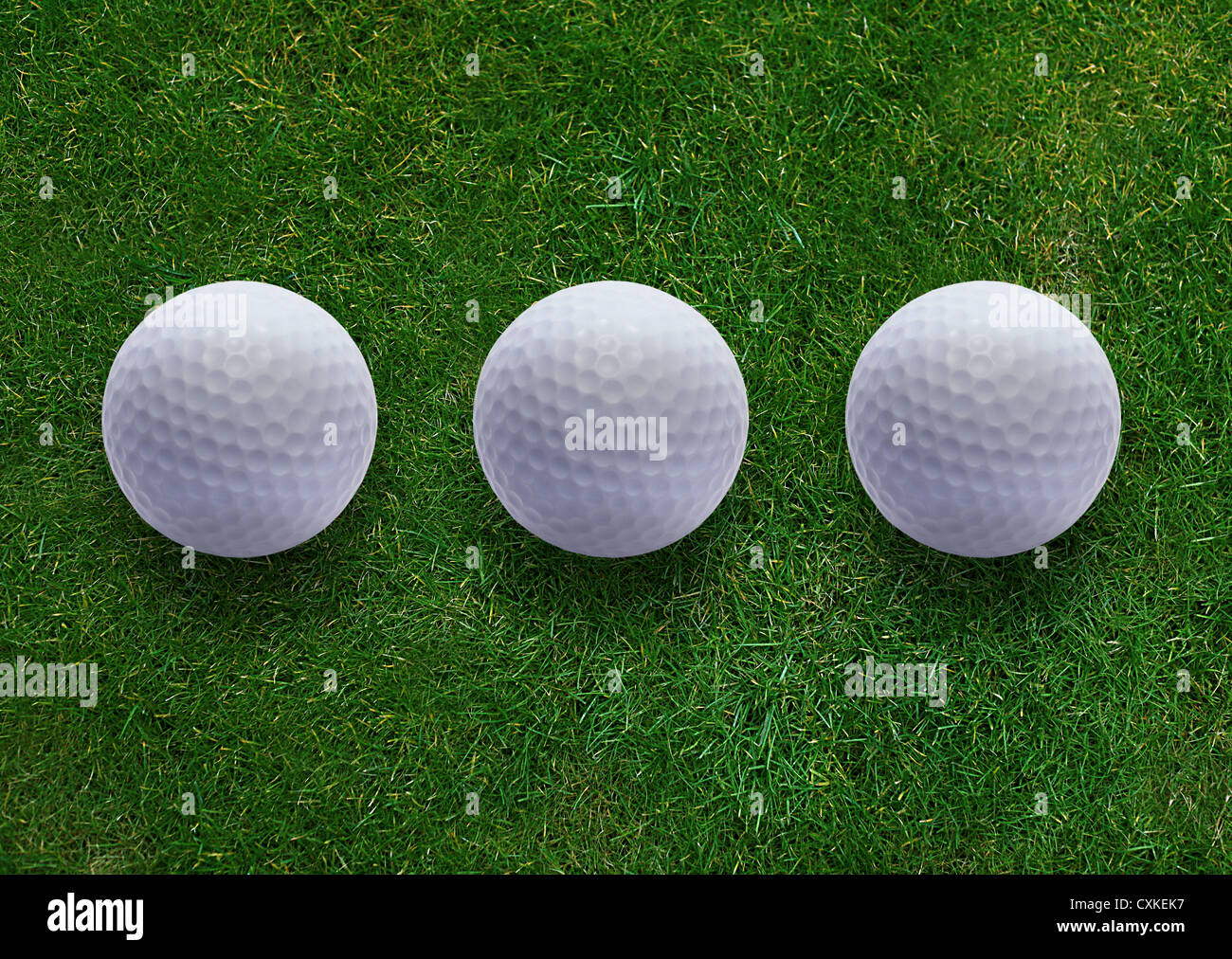 Three golf ball on green grass land Stock Photo Alamy