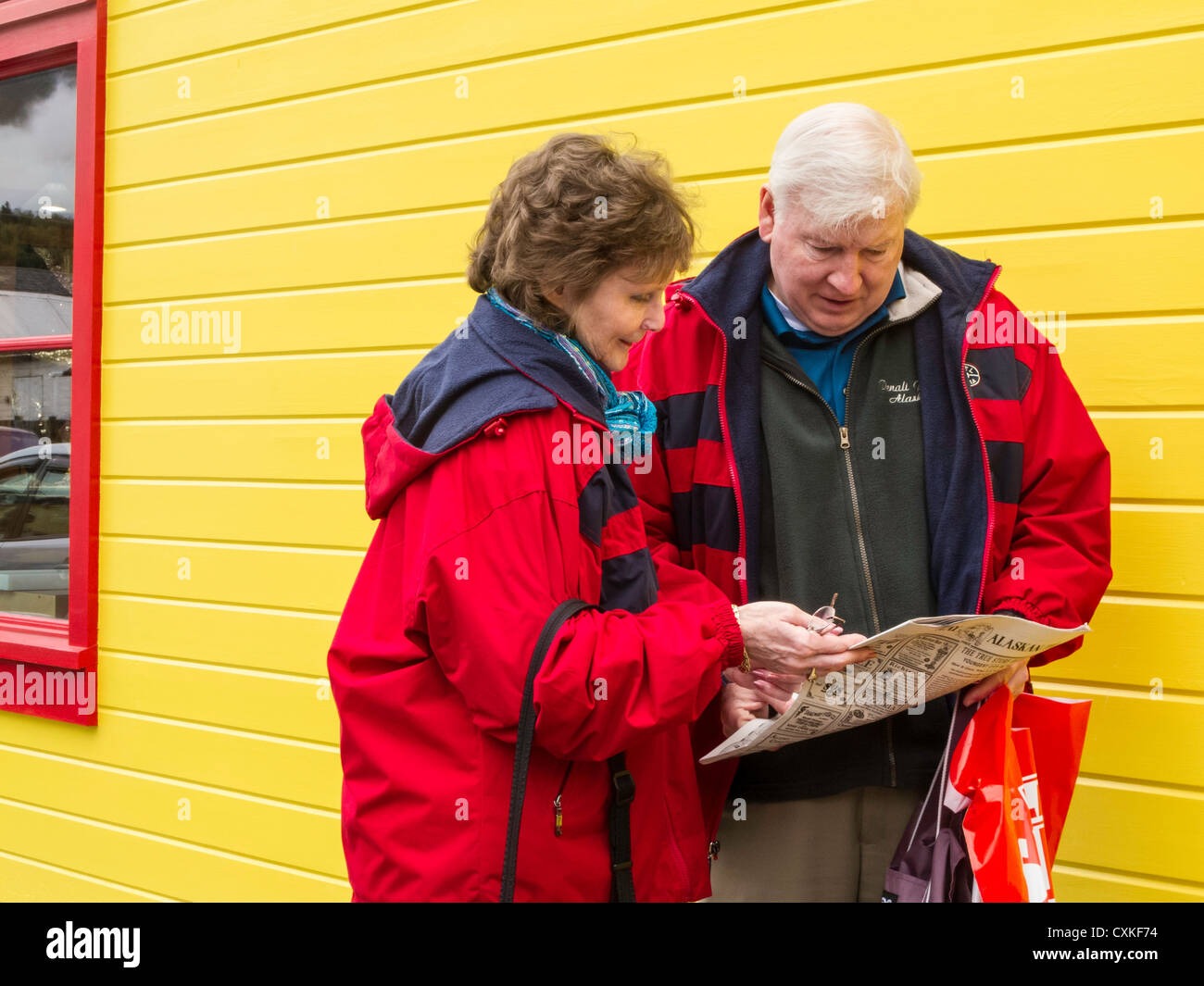 Mature Tourist Couple Check a Guide Stock Photo