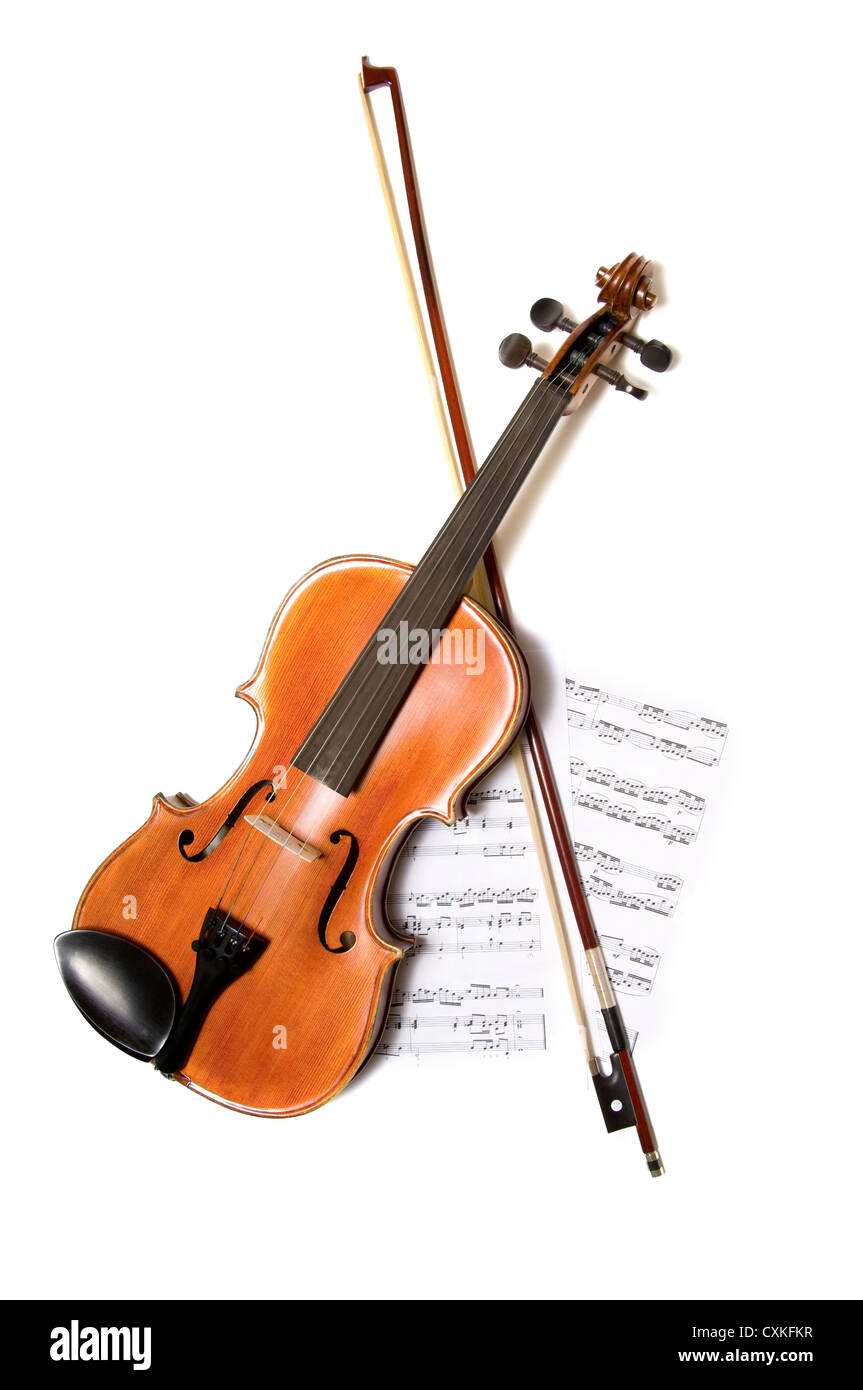A violin and bow on top of a piece of sheet music on white background, with copy space Stock Photo