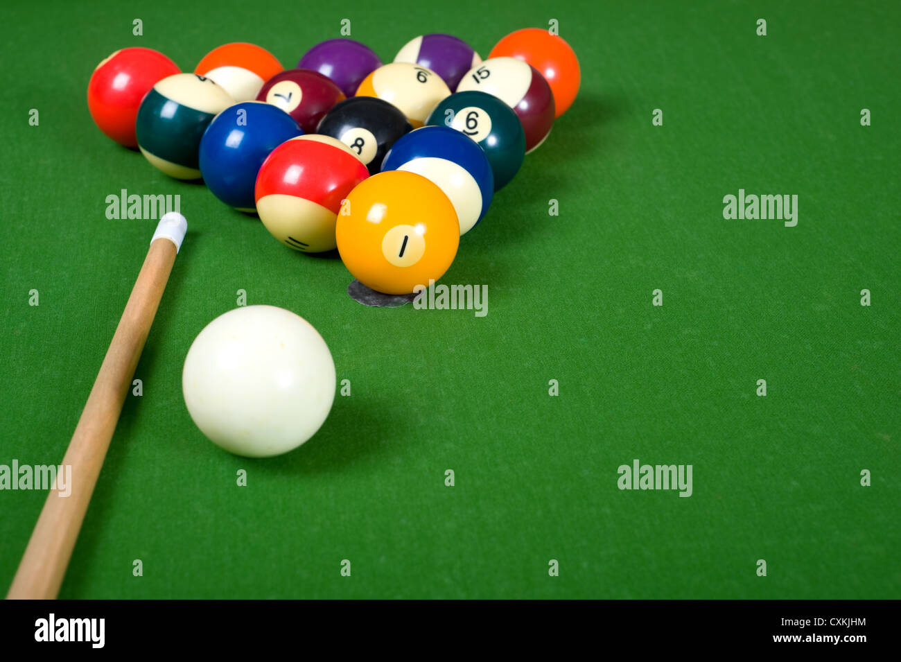 A set of billiards or pool balls on a green felt table with copy space