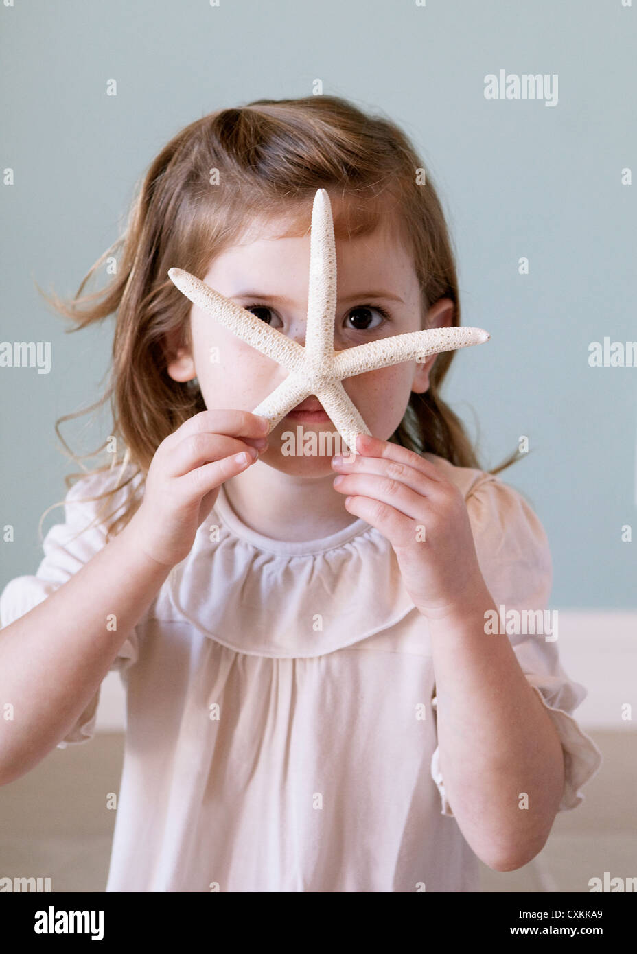 Young girl with starfish Stock Photo