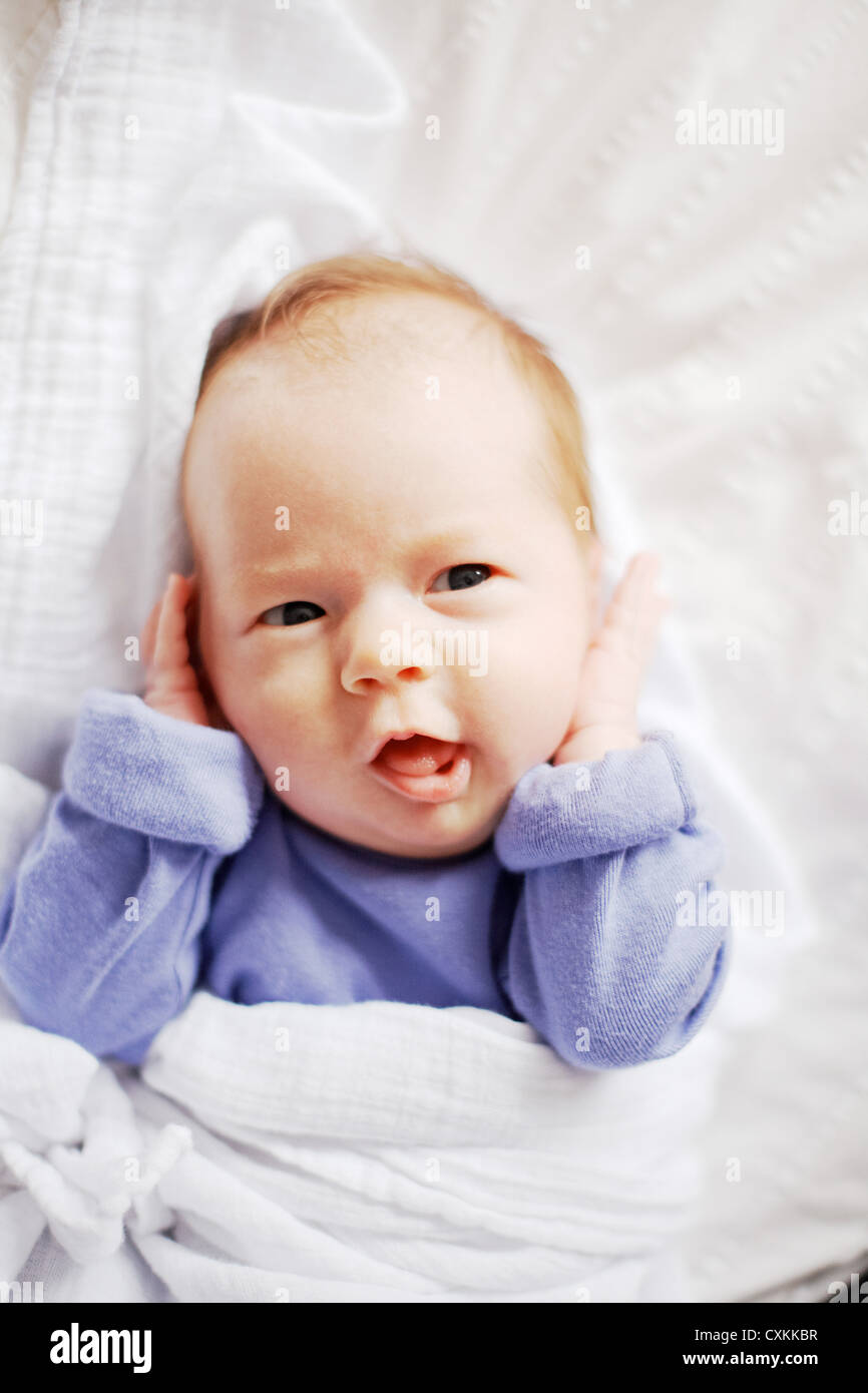 Young baby making faces Stock Photo