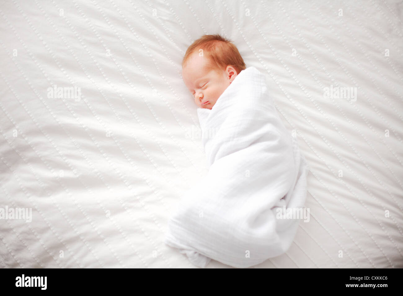 Swaddled sleeping baby Stock Photo Alamy