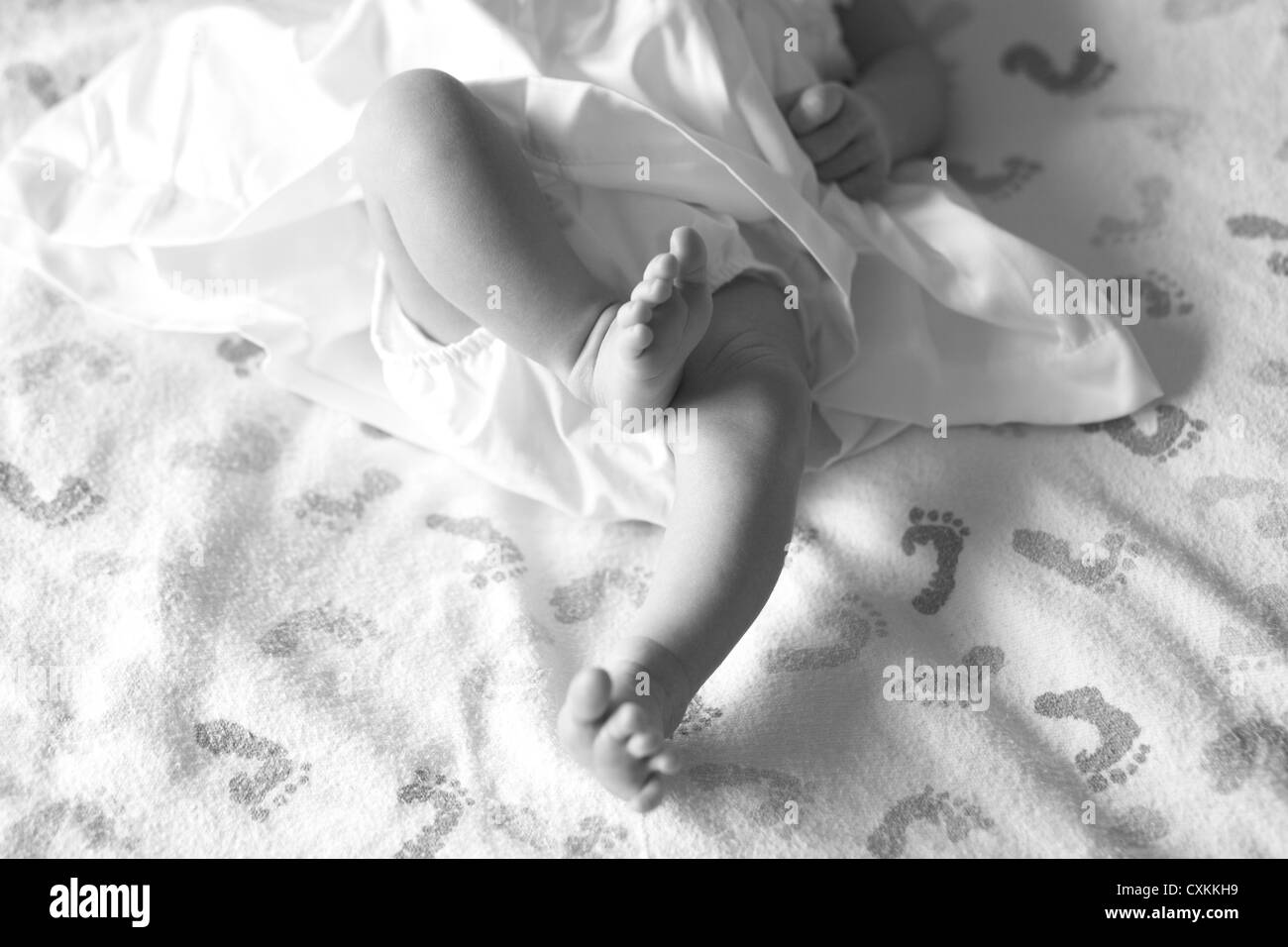 infant lying on a baby feet blanket Stock Photo Alamy