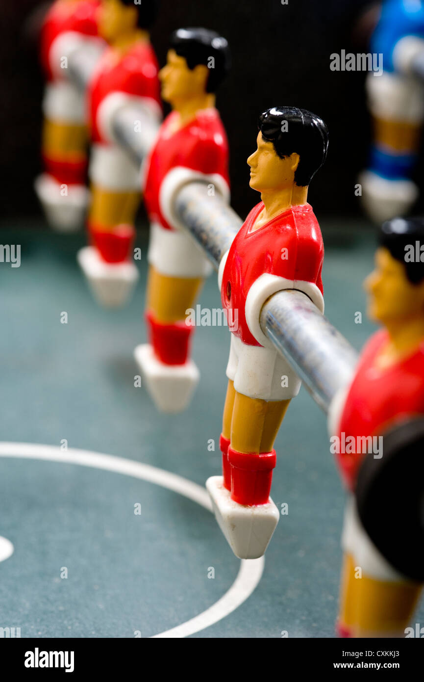 a row of foosball or table soccer playing pieces Stock Photo