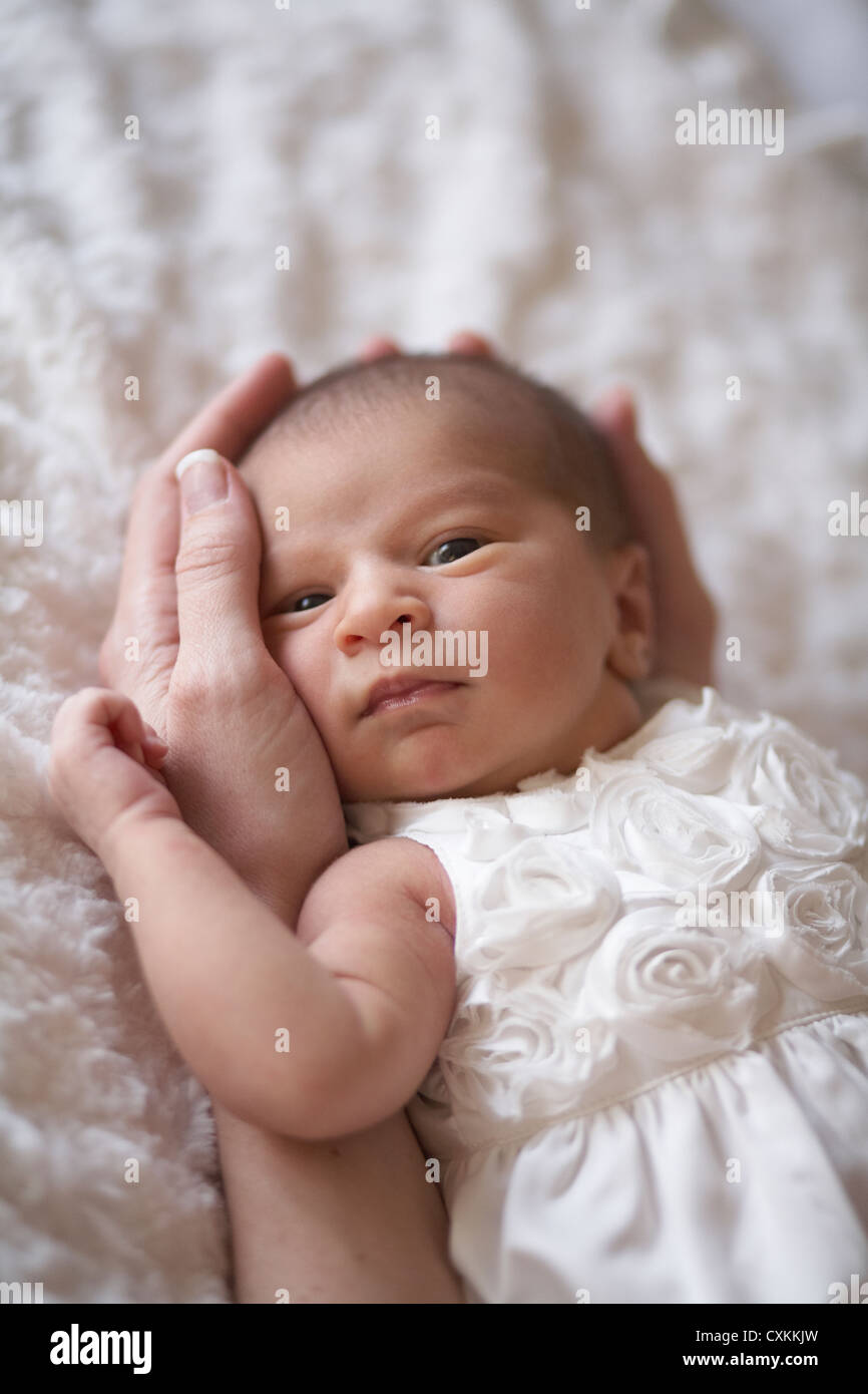 infant being held in her mother's hands Stock Photo