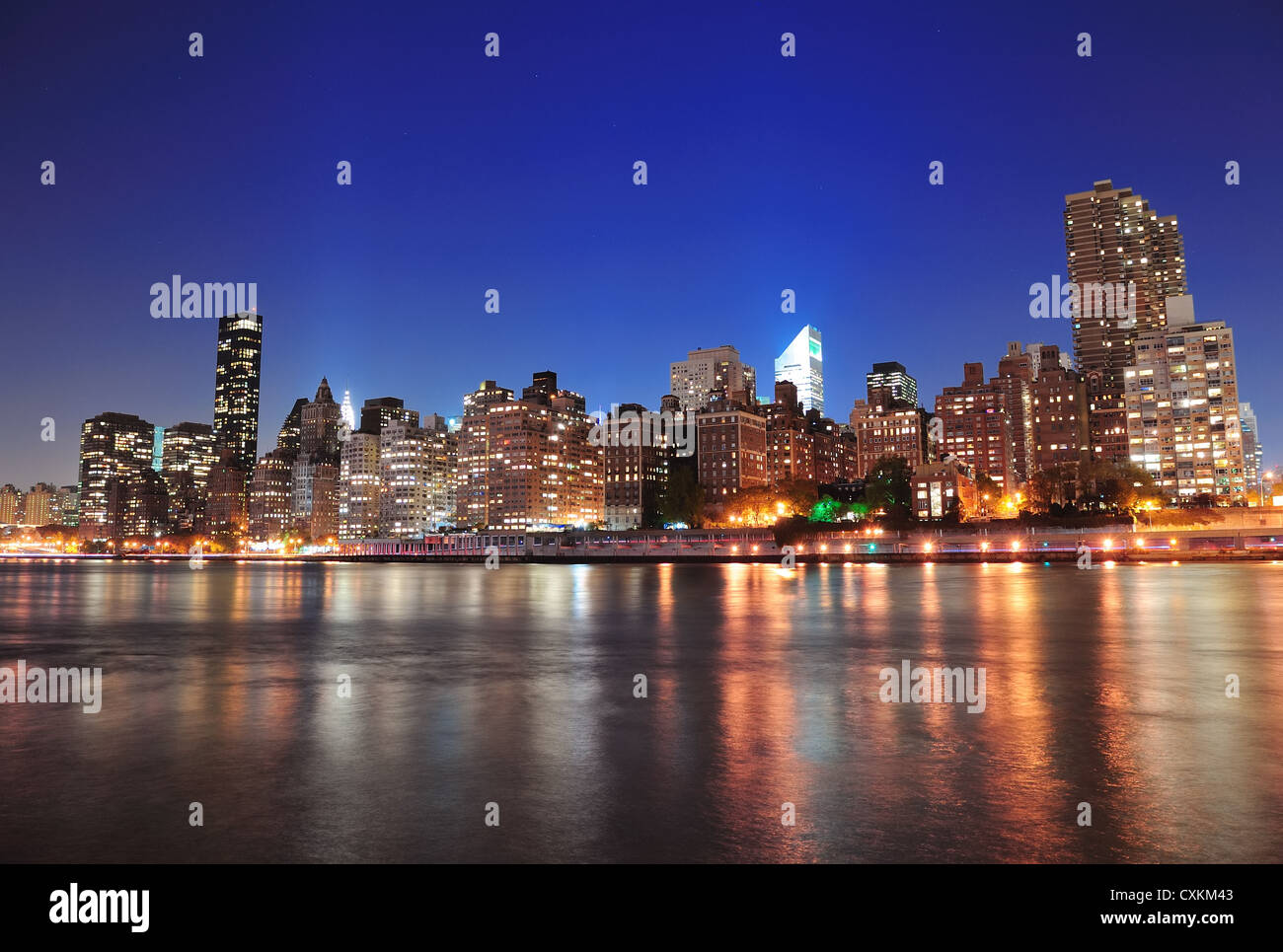 New York City Manhattan midtown skyline at night over East River Stock ...