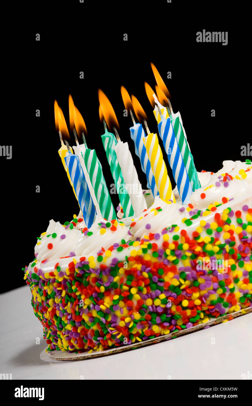 A colorful birthday cake with candles Stock Photo - Alamy