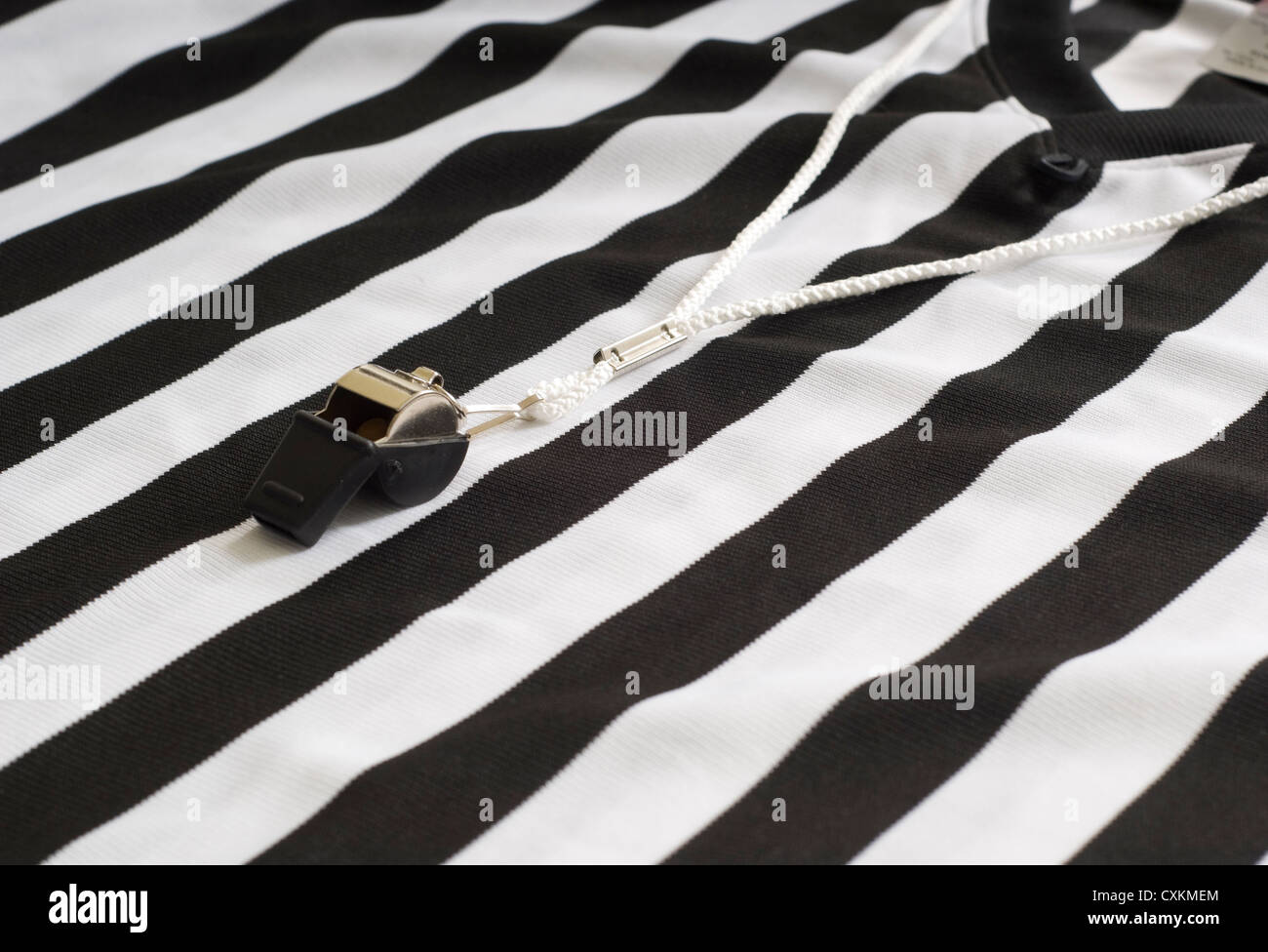 A referee striped shirt with a whistle, sports equipment, authority concept Stock Photo