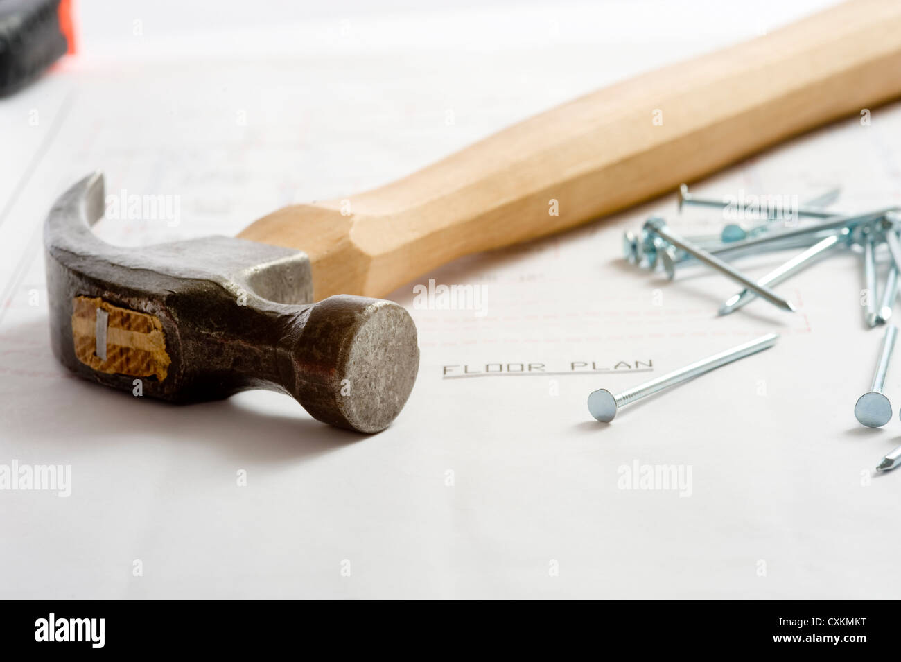 A floor plan with hammer, nails lying on top Stock Photo Alamy