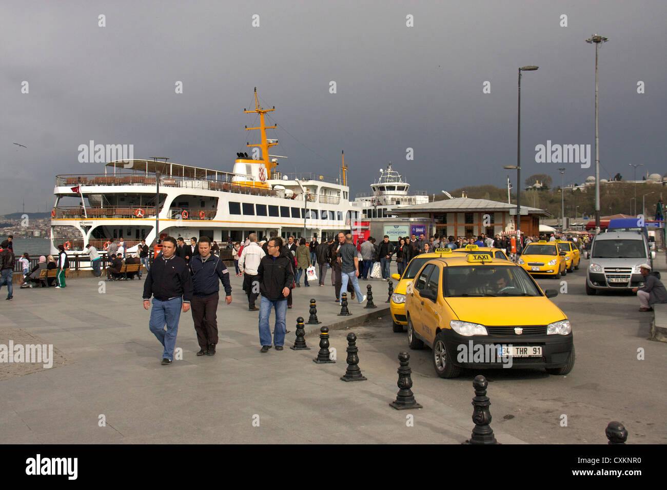 yellow taxi cars or cabs infront of eminonu ferry boat terminal near galata bridge,istanbul,turkey Stock Photo