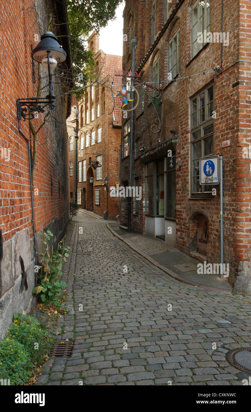Narrow cobbled street in old town Lübeck, Schleswig-Holstein, Germany. Stock Photo