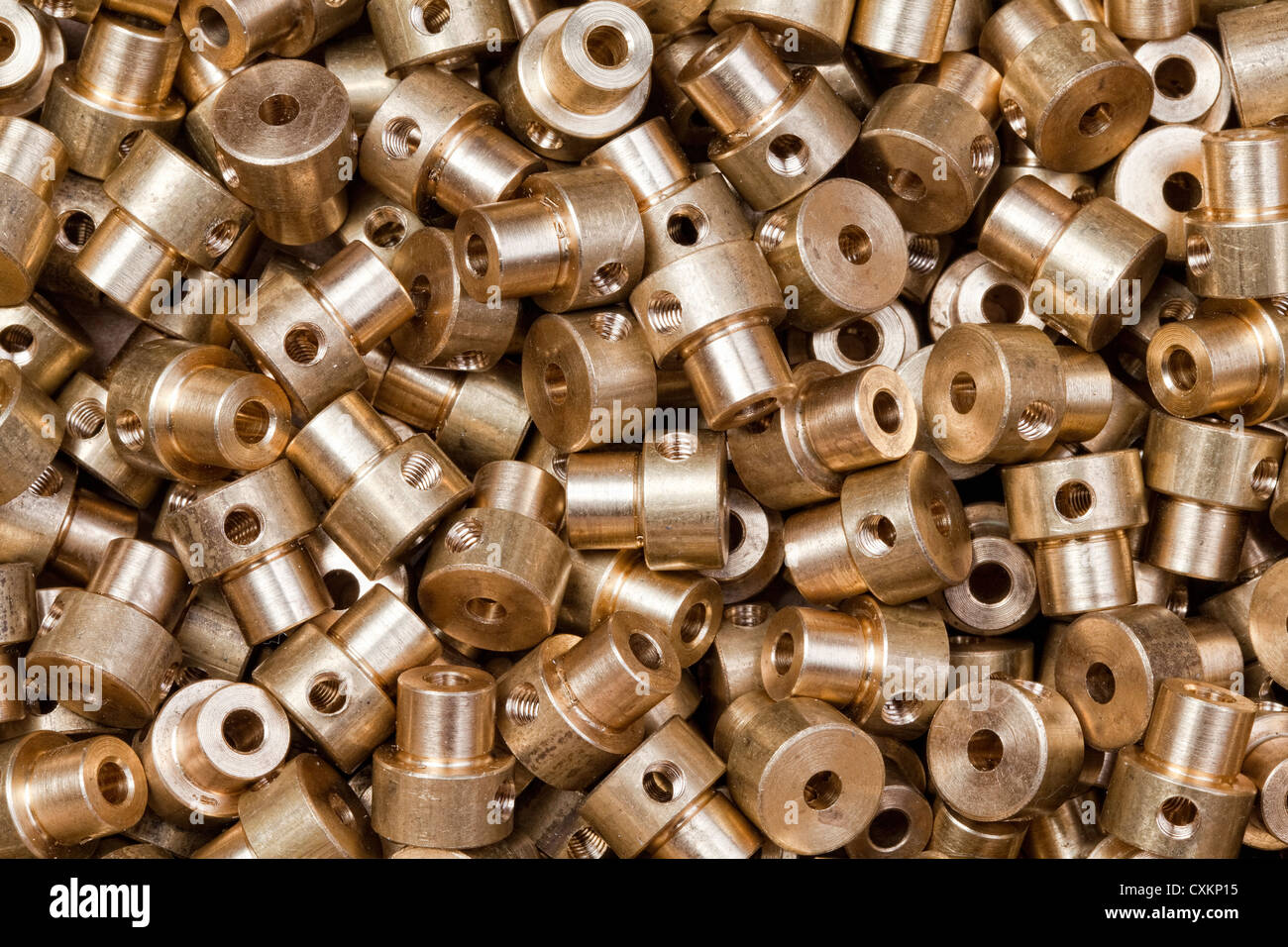 A pile of small, industrially produced parts made of brass Stock Photo
