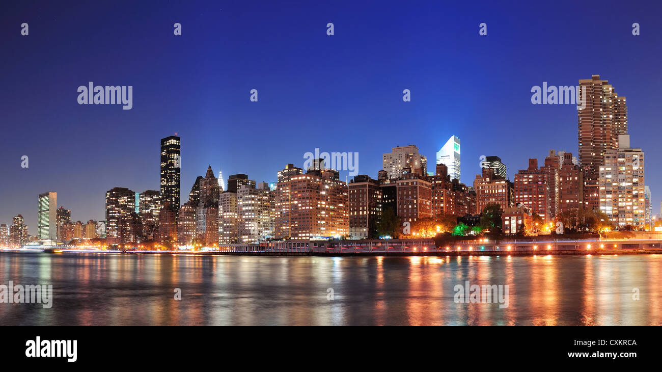 New York City Manhattan midtown skyline at night over East River Stock ...
